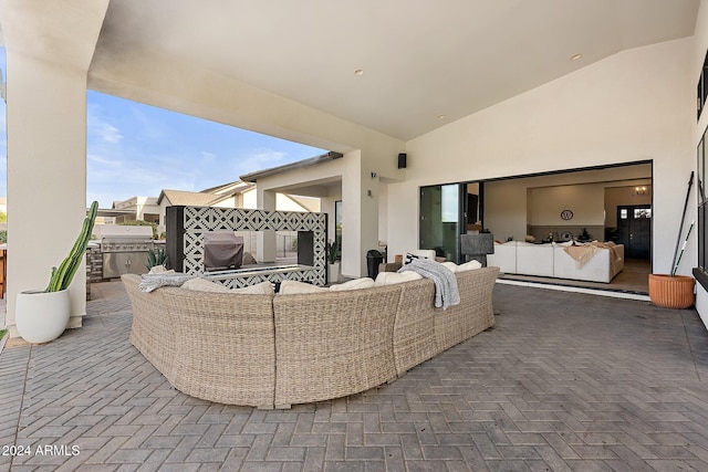 view of patio / terrace with an outdoor fireplace and a grill