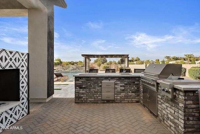 view of patio / terrace with area for grilling and a water view