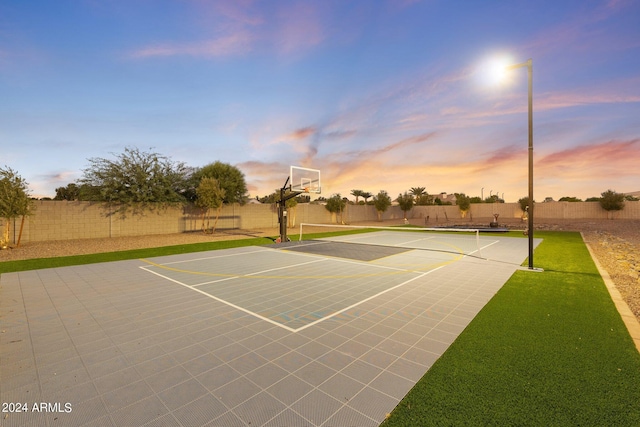 view of sport court featuring a yard