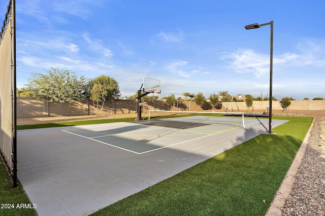 view of sport court with a yard