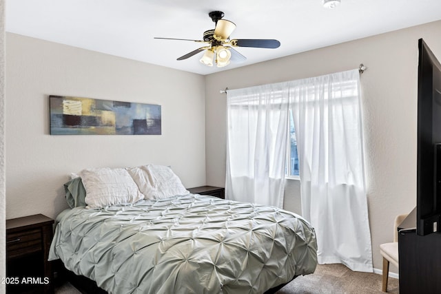 bedroom with a ceiling fan and carpet flooring