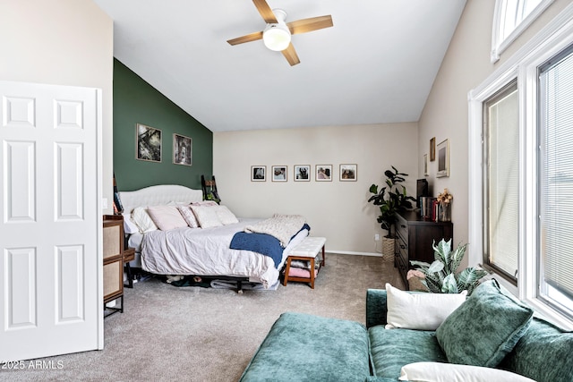 bedroom with a ceiling fan, multiple windows, carpet, and vaulted ceiling