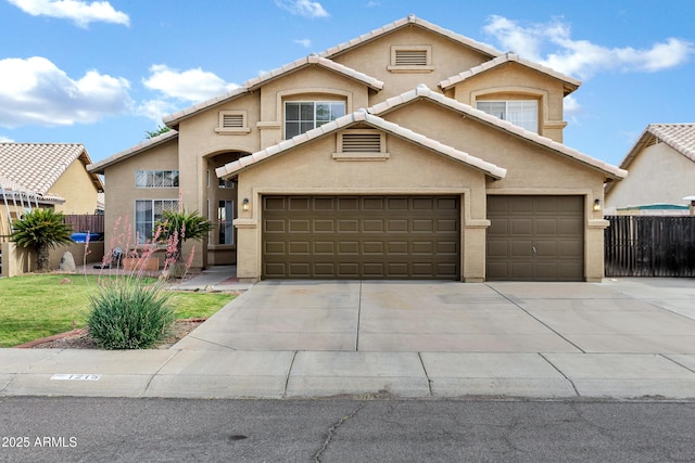 traditional home featuring fence, stucco siding, driveway, and a garage