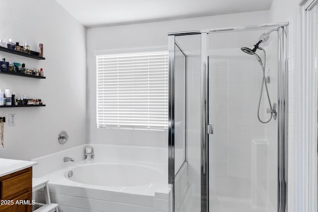 bathroom featuring vanity, a bath, a wealth of natural light, and a shower stall