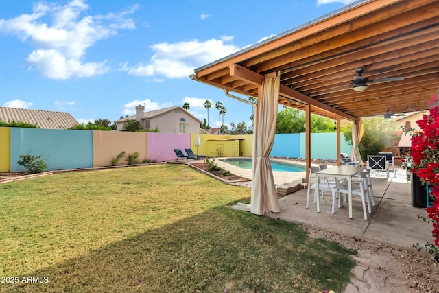 view of yard featuring a fenced backyard, a fenced in pool, ceiling fan, and a patio area