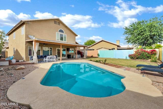 rear view of house featuring ceiling fan, stucco siding, a fenced backyard, a fenced in pool, and a patio