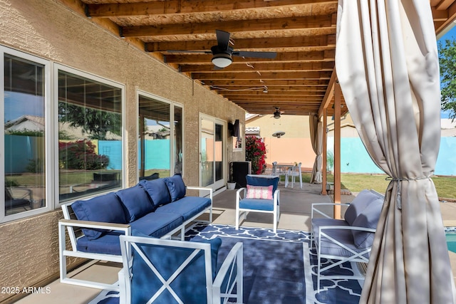view of patio with outdoor dining area, ceiling fan, and an outdoor living space