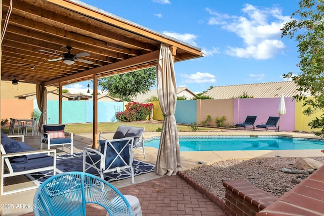 view of pool with a patio, a ceiling fan, a fenced backyard, and a fenced in pool