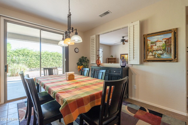 dining space with tile patterned flooring and ceiling fan