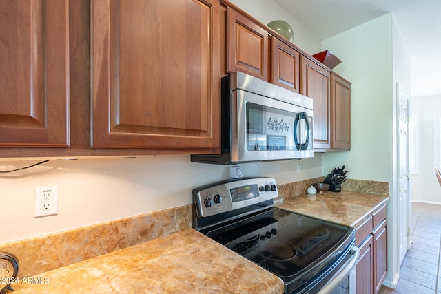 kitchen with appliances with stainless steel finishes and tile patterned floors