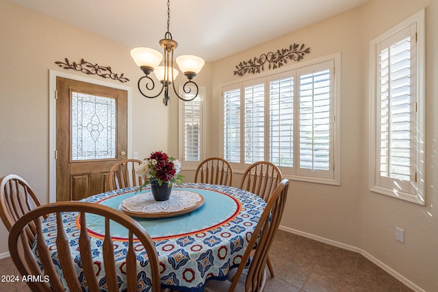 tiled dining area with a notable chandelier and plenty of natural light