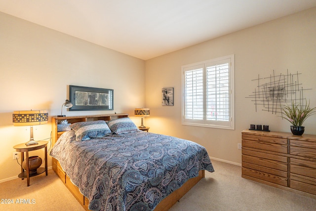 bedroom featuring light carpet