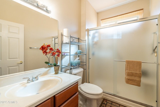 bathroom with tile patterned flooring, vanity, a shower with door, and toilet