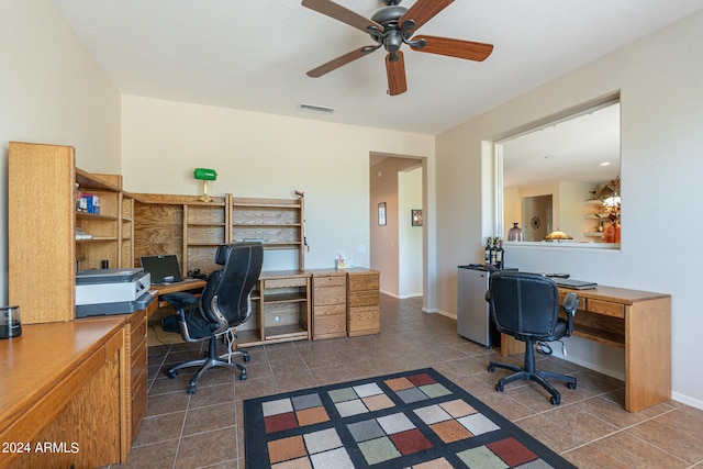 home office featuring ceiling fan and dark tile patterned flooring