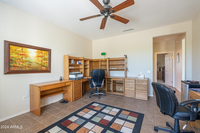 tiled home office featuring ceiling fan