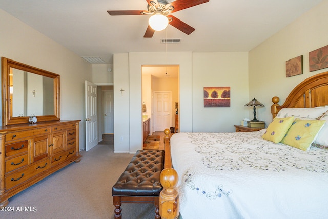 carpeted bedroom featuring ceiling fan and ensuite bathroom