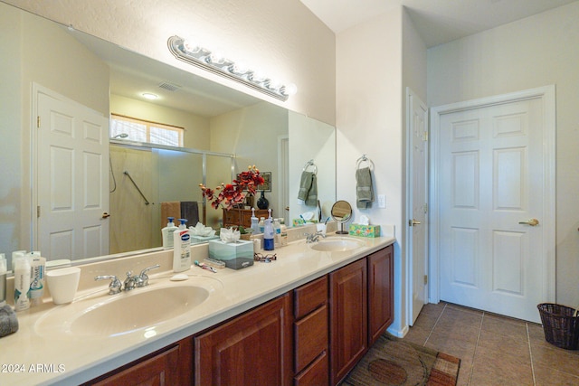 bathroom with walk in shower, vanity, and tile patterned floors