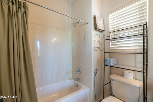 bathroom with shower / tub combo and toilet