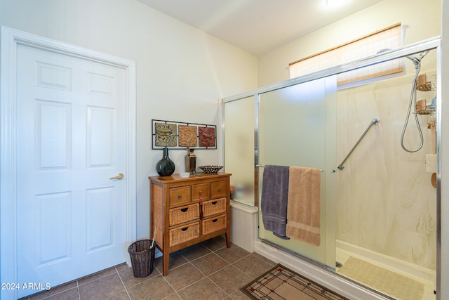 bathroom featuring tile patterned flooring, walk in shower, and vanity