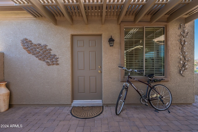 property entrance with a pergola