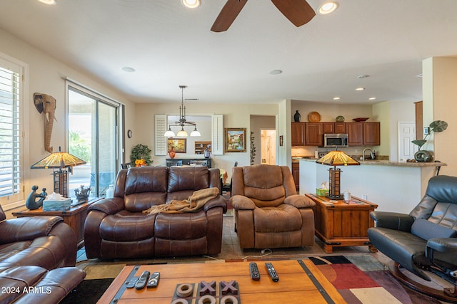 living room with ceiling fan and sink