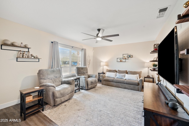 living room with hardwood / wood-style flooring and ceiling fan