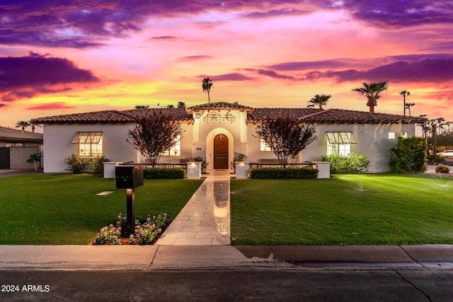 mediterranean / spanish-style home featuring a yard