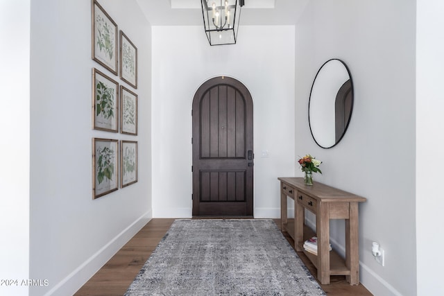 foyer entrance with a chandelier and hardwood / wood-style flooring