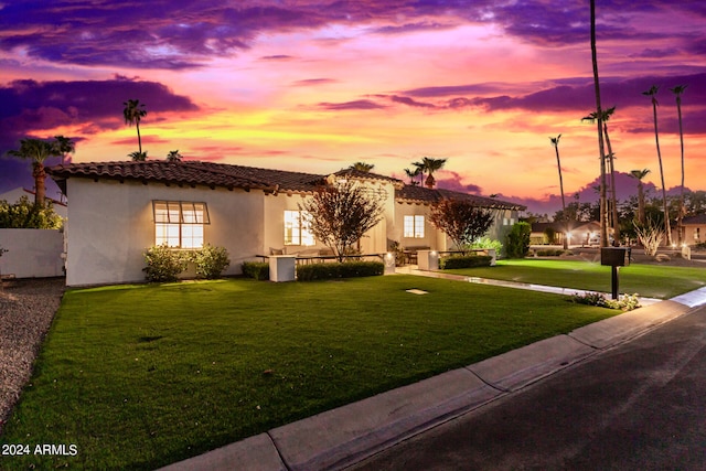 mediterranean / spanish-style home featuring a yard