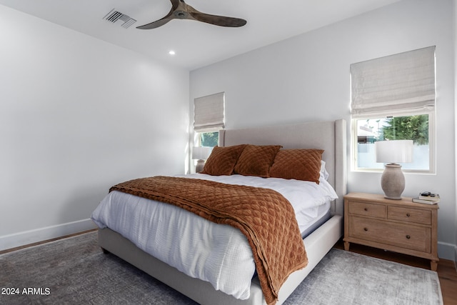 bedroom featuring ceiling fan and dark hardwood / wood-style floors