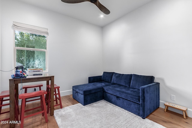 living room with hardwood / wood-style flooring and ceiling fan