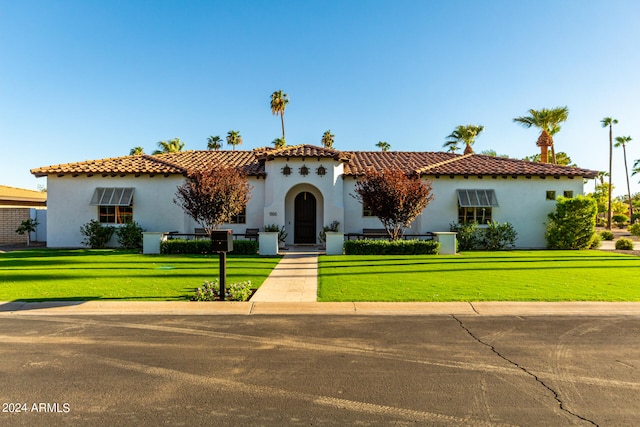 mediterranean / spanish-style home with a front yard