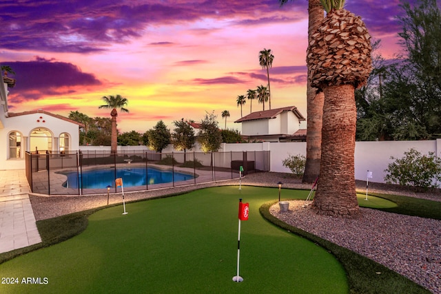 view of pool at dusk