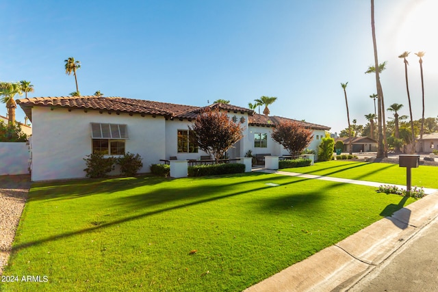 mediterranean / spanish house with a front lawn