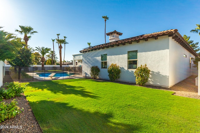 view of yard with a fenced in pool