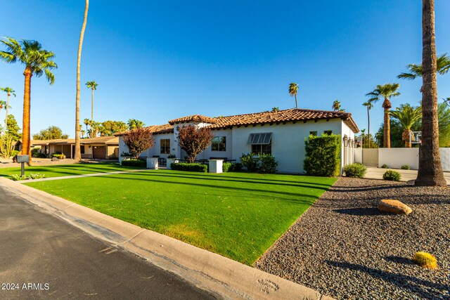 mediterranean / spanish-style home with a front yard