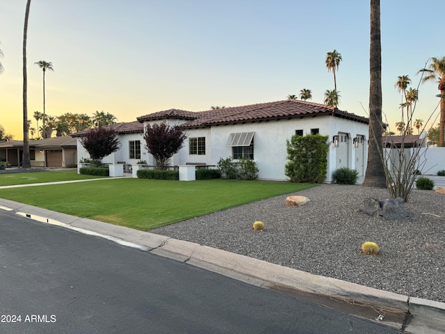 mediterranean / spanish house featuring a yard