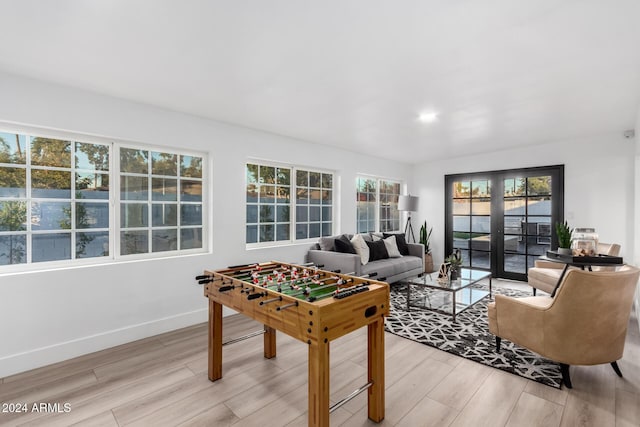 playroom featuring light hardwood / wood-style floors and french doors