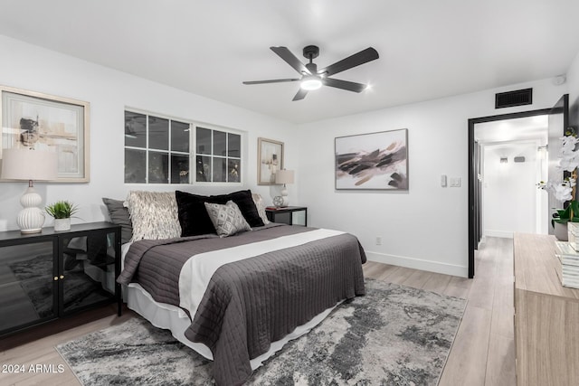 bedroom with ceiling fan and light hardwood / wood-style floors