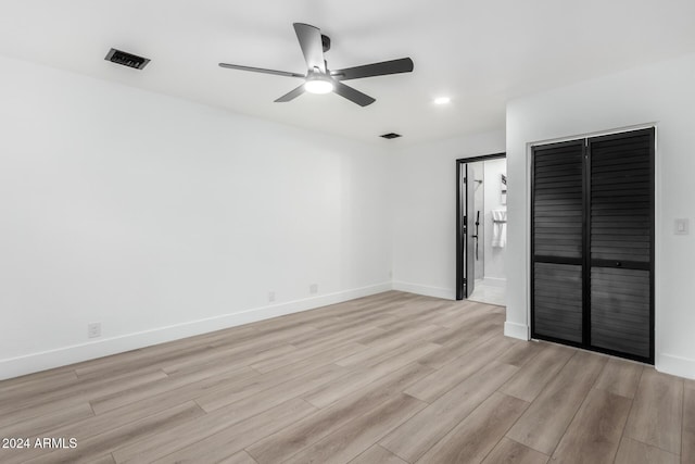 unfurnished bedroom featuring light wood-type flooring, a closet, and ceiling fan