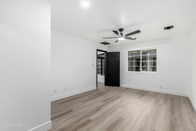 spare room featuring light hardwood / wood-style flooring and ceiling fan