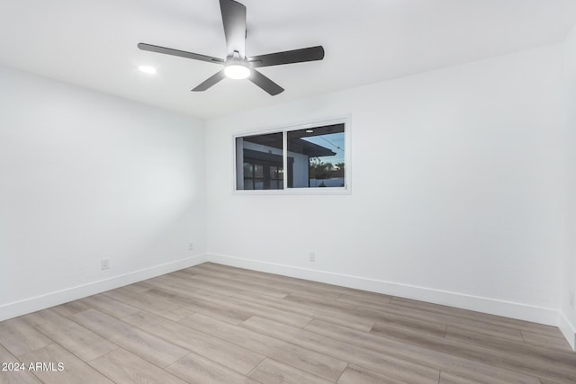 unfurnished room with light wood-type flooring and ceiling fan