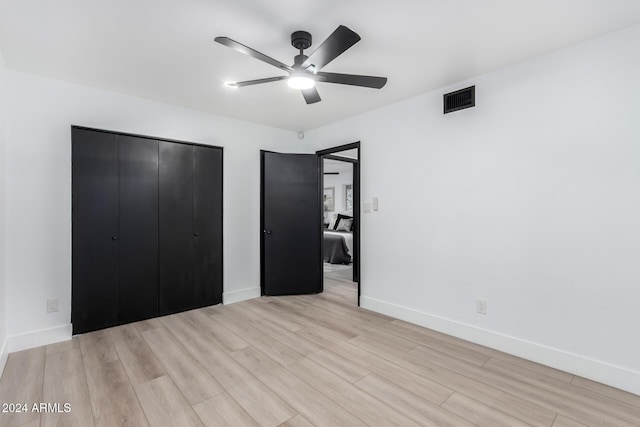 unfurnished bedroom with ceiling fan and light wood-type flooring