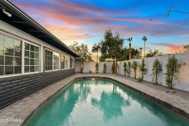 view of pool at dusk