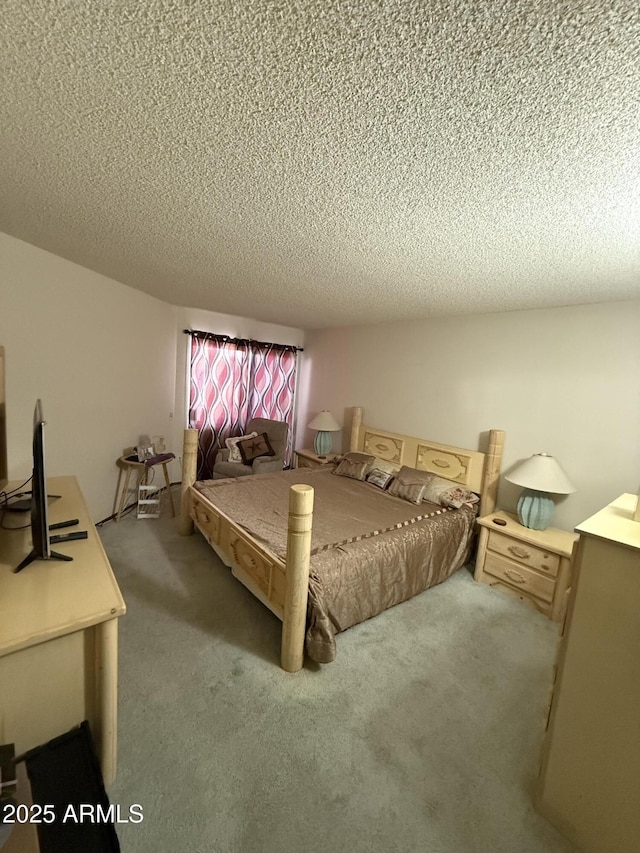 bedroom with carpet and a textured ceiling