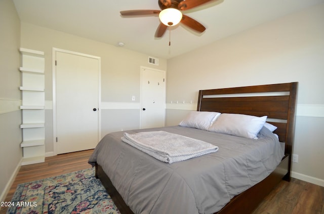 bedroom with ceiling fan and dark hardwood / wood-style flooring