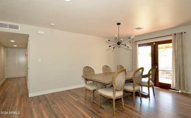 dining space with a notable chandelier and dark hardwood / wood-style floors