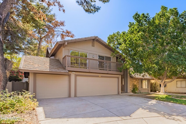 front of property with a garage and a balcony