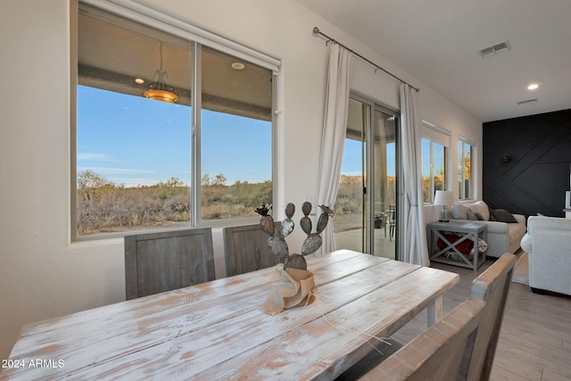 dining space with hardwood / wood-style floors