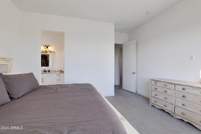 carpeted bedroom featuring ensuite bathroom